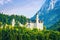 Beautiful medieval Neuschwanstein castle standing among forest