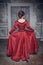 Beautiful medieval woman in red dress, back