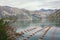 Beautiful Mediterranean landscape on cloudy autumn day. Longline culture mussel farm. Montenegro, Bay of Kotor