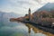 Beautiful mediterranean landscape. Small seaside village, clouds and mountains are reflected in water. Montenegro, Kotor Bay