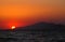 Beautiful mediterranean sunset over over the island of kos with an orange evening sky and light reflected in a dark calm sea