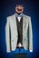 Beautiful men`s grey jacket suit with shirt and bow tie on a dummy or mannequin on blue background