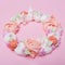 Beautiful meringue wreath on pink pastel background, concept