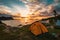 Beautiful mesmerizing seascape at sunset with an orange tent on a foreground