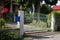 Beautiful Metal entry Gate. Green garden and Sunny day.