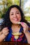 Beautiful Mexican woman savoring a delicious vanilla and caramel ice cream in a terrace of a cafeteria