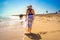 Beautiful mid-adult woman walking on sunny beach Santa Maria, Sal Island, Cape Verde