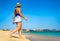 Beautiful mid-adult woman walking on sunny beach Santa Maria, Sal Island, Cape Verde