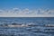 Beautiful midday blue sea sky clouds and waves