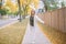 Beautiful middle age Caucasian woman with short hair walking in autumn fall street outdoors. Young woman with short haircut in