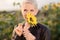 Beautiful middle age woman in a rural field scene outdoors standing between sunflowers