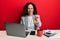 Beautiful middle age woman working at the office drinking a cup of coffee smiling cheerful offering palm hand giving assistance