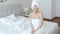 Beautiful middle aged blonde woman wrapped in towel white towel walking