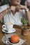 Beautiful middle-aged Caucasian woman enjoying a hot cup of coffee with milk and an indulging dessert