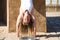 Beautiful middle-aged woman doing yoga in the street. Detail of head and chest. Woman is doing relaxation and tranquility postures