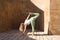 Beautiful middle-aged woman doing yoga in the street. The woman is doing relaxation and tranquility postures. Woman is wearing