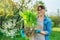 Beautiful middle aged woman with rooted hosta plant looking at camera