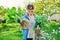 Beautiful middle aged woman with rooted plants looking at camera