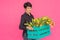 Beautiful middle-aged woman with yellow tulips on pink background. Floristics, holidays and gifts concept