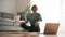 Beautiful middle-aged woman yoga teacher conducting online video lesson