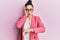 Beautiful middle eastern woman wearing business jacket and glasses looking at the watch time worried, afraid of getting late