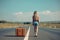 Beautiful millennial woman in casual wear hitchhiking on roadside. Generative AI