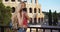 Beautiful millennial woman facing camera takes photo on phone near Colosseum