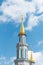 Beautiful minaret with golden crescent against blue sky