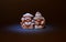 Beautiful miniature netsuke of a pair of fish on dark background