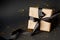 Beautiful minimal christmas, black friday golden black decor and paper craft gift box with satin black ribbon on dark black