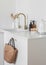 Beautiful minimalist kitchen interior with kitchen tools and a straw bag
