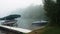 Beautiful Minnesota lake on a foggy morning with calm waters and a couple pleasure boats.