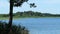 Beautiful Minnesota lake scene with boats, people, water and reeds.