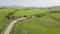Beautiful and miraculous colors of green spring panorama landscape of Tuscany, Italy. Sunny morning near Pienza. Aerial view.