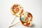 beautiful with mirror glaze delicious handmade lollipops on white background