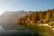 Beautiful mirror lake in Bohinj, Slovenia captured surrounded by lakeside trees in fall colors