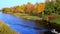 Beautiful Mississippi River with autumn foliage and a small fishing boat.