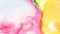 Beautiful mix of pink yellow and a little green paint on white background. Abstract bright multi-colored colors dissolve