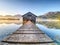 Beautiful mmorning at lake with traditional wooden boat house.