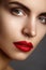 Beautiful model with fashion make-up. Close-up portrait woman with glamour lip gloss makeup and bright eye shadows.