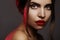 Beautiful model with fashion make-up. Portrait woman with glamour red lips makeup, strong eyeshadows, hairstyle