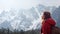 Beautiful model Looking up to the sky, side view with the sun shine on face in travel with the snow mountain background,