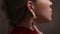 Beautiful model touching her earrings which hanging and oscillates on a ear, slow motion, 10 fps