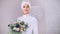 Beautiful model in white muslim wedding dress and bridal headdress with flowers
