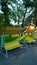 Beautiful modern bench-swing in a public Park of the city at sunset. Vertical view