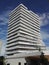 Beautiful modern building in immaculate white, rising into a blue sky