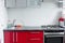 Beautiful modern clean red kitchen in small apartment full shot