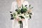Beautiful modern wedding bouquet in the hands of the bride. black and white color scheme