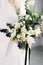 Beautiful modern wedding bouquet in the hands of the bride. black and white color scheme