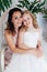 Beautiful mom and daughter in white dresses in close family